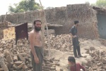 man with flood damaged house Charsadda Pakistan